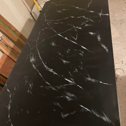 A black concrete surface that had several defects was restored with epoxy