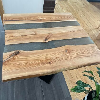 Table with silver epoxy columns. Made with a glossy top layer