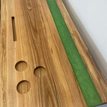 A large serving tray with an epoxy column and space for candles, a glass, a phone