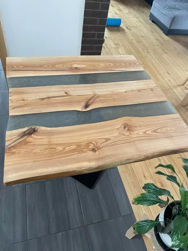Table with silver epoxy columns. Made with a glossy top layer