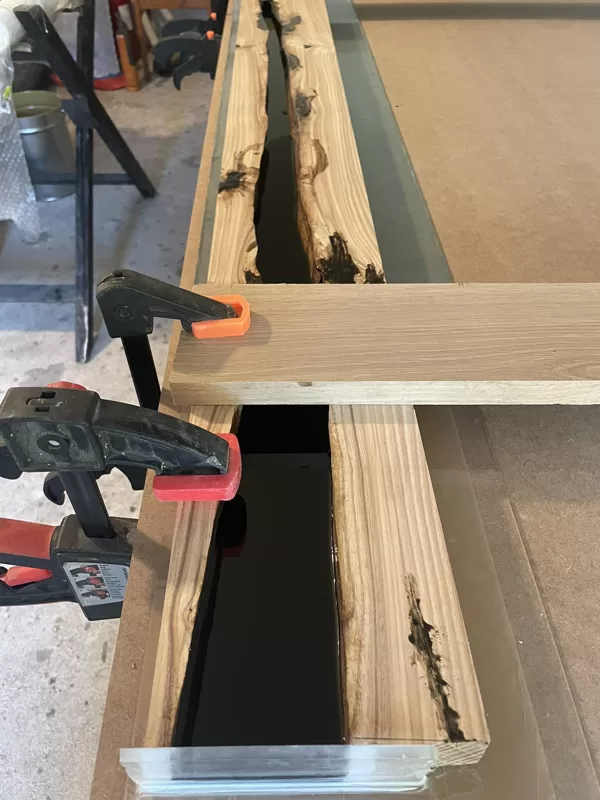 Casting process, elm stair railing with black epoxy bar